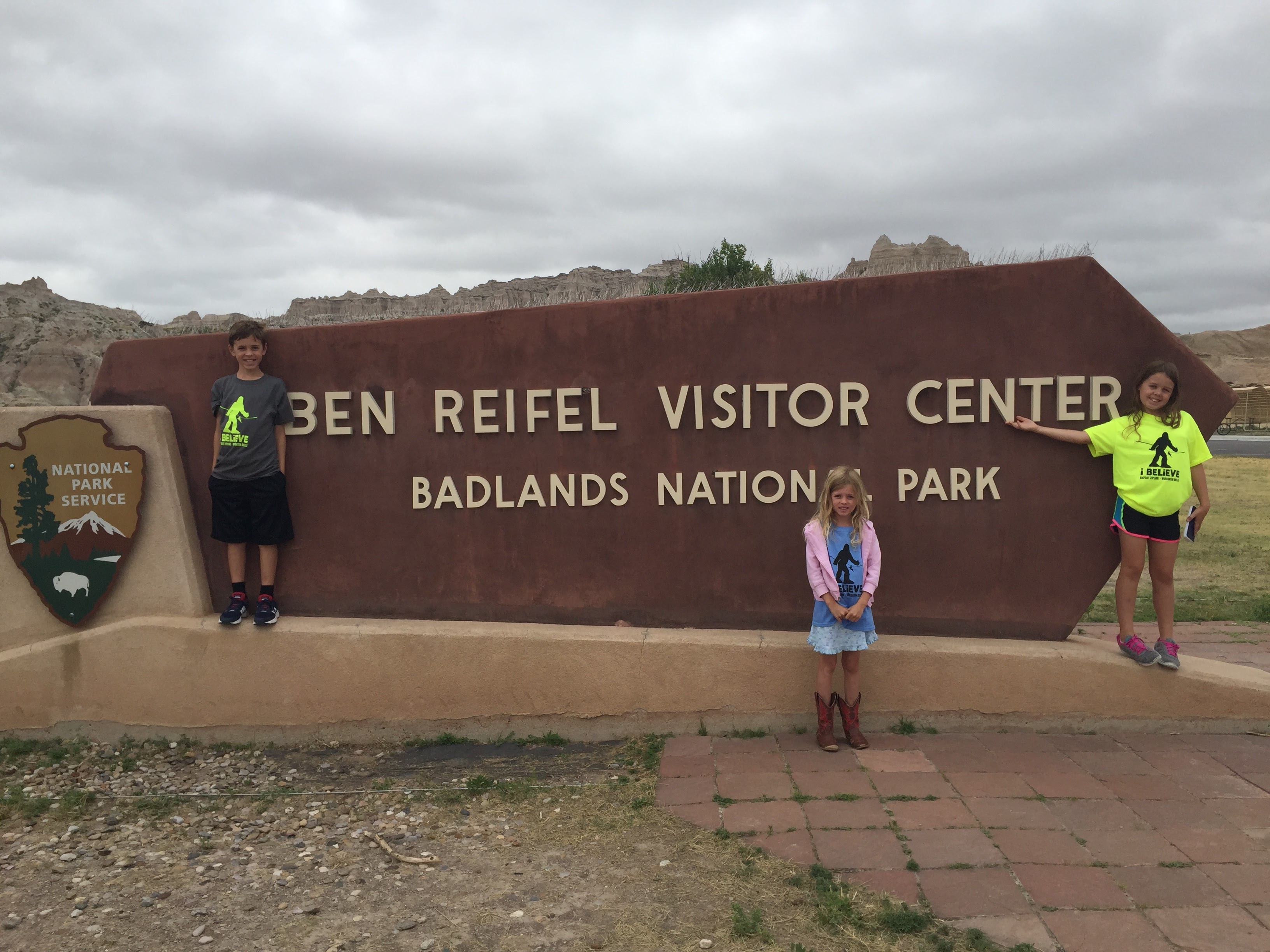 children at Ben Reifel Visitor Center sign