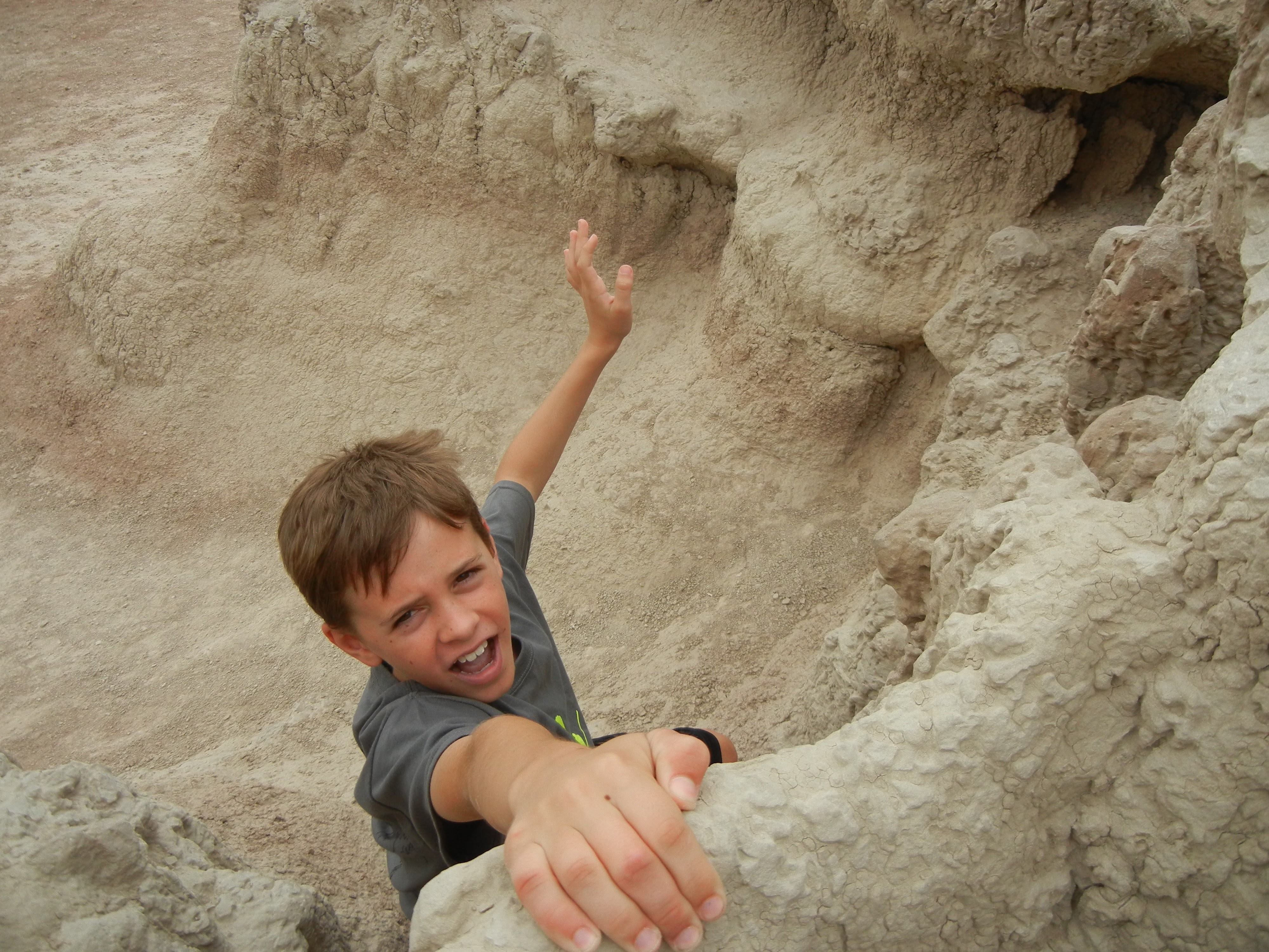 kid pretending to dangle off cliff